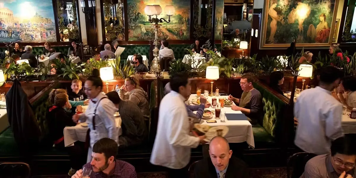 Busy Clyde's dining room with staff serving large parties and walk-ins