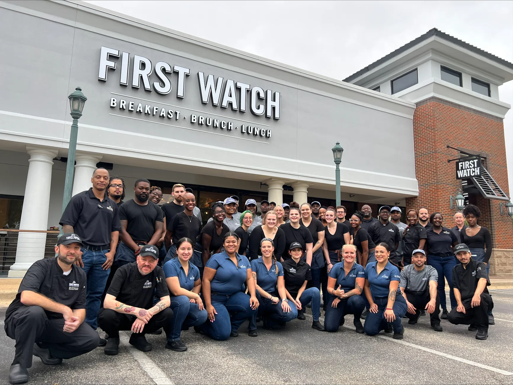 First Watch team members gathered in front of restaurant