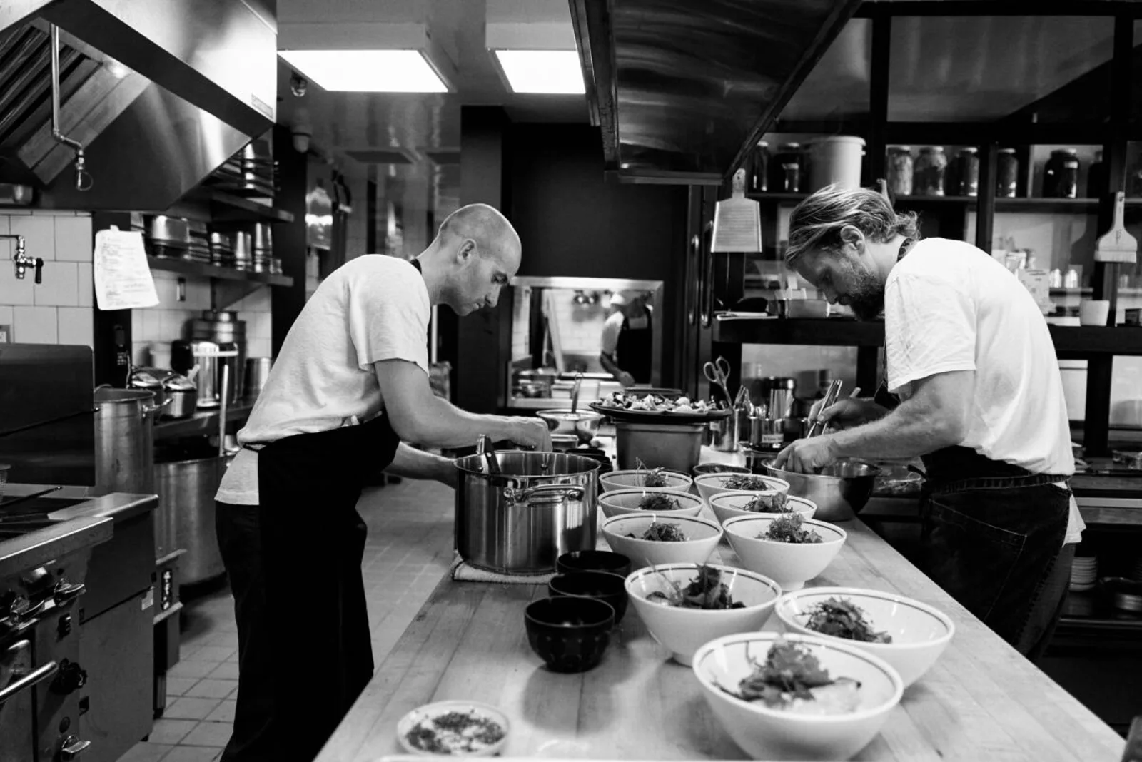 Gjelina Group kitchen team plating dishes — every tip dollar flows through ADP payroll