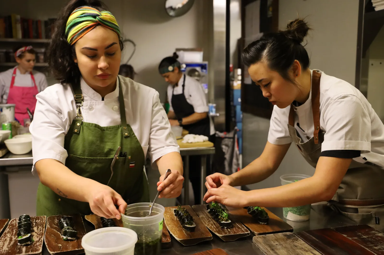 Hai Hospitality kitchen team plating during service