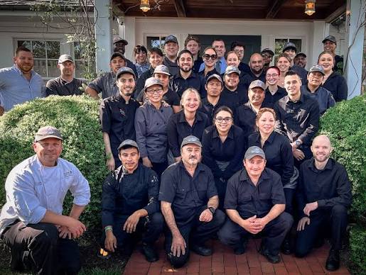 Rooted Hospitality Group team members gathered outside one of the group's restaurants